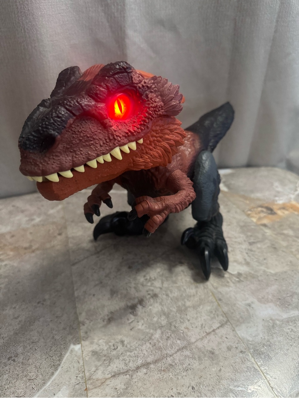 Red and Black Interactive Reptile Toy with Glowing Eye